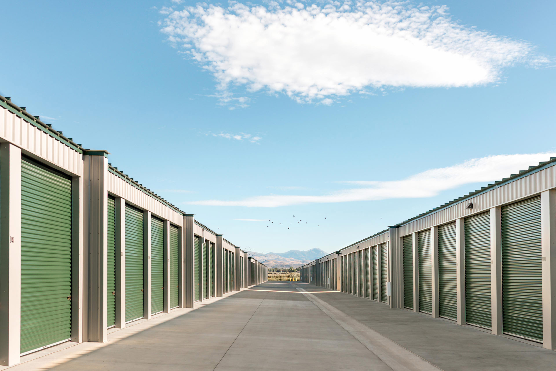 a row of storage units with mountains in the background 3